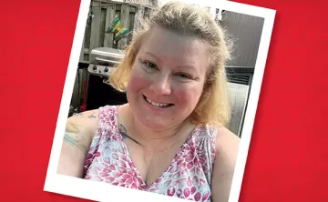 A photo of Angela in her backyard wearing a floral shirt