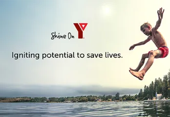 children jumping into lake from dock in summer YMCA Shine On Logo, slogan 'Igniting Potential to Save Lives'