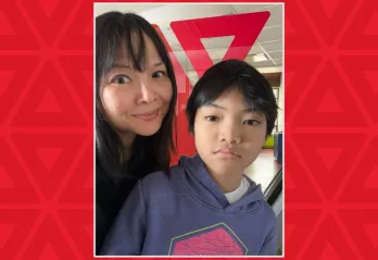 mother and son in front of YMCA sign