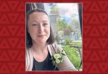 women takes selfie with a flower in her shirt pocket