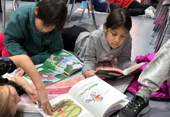 Kids in after school program lay on floor and read books