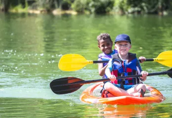 boys in kayak on lake