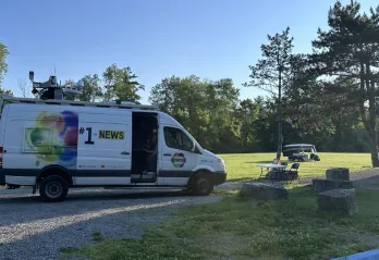 Photo of a CHCH news van at camp 