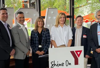 Group of people at event in front of YMCA logo