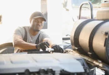 Man working on an undetermined truck part