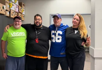 Three men and a woman smiling at the camera