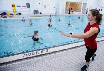 Female Instructor leading an Aquafit class in pool
