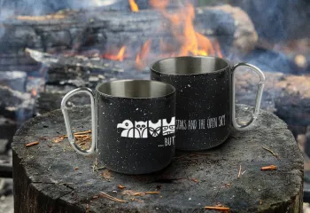 Wanakita mugs sitting by campfire