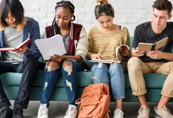 Youth looking at books studying