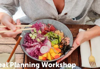 Person eating a bowl with fruits and veggies and fish with chopsticks 