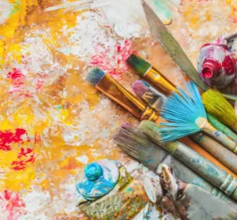 Used paints, paintbrushes and canvas