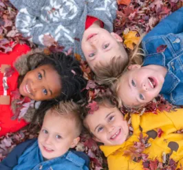 Group of kids laying in leaves
