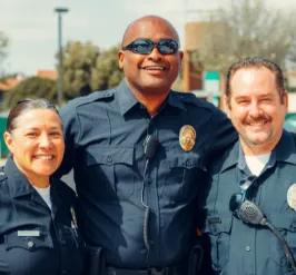 Three police offers smiling