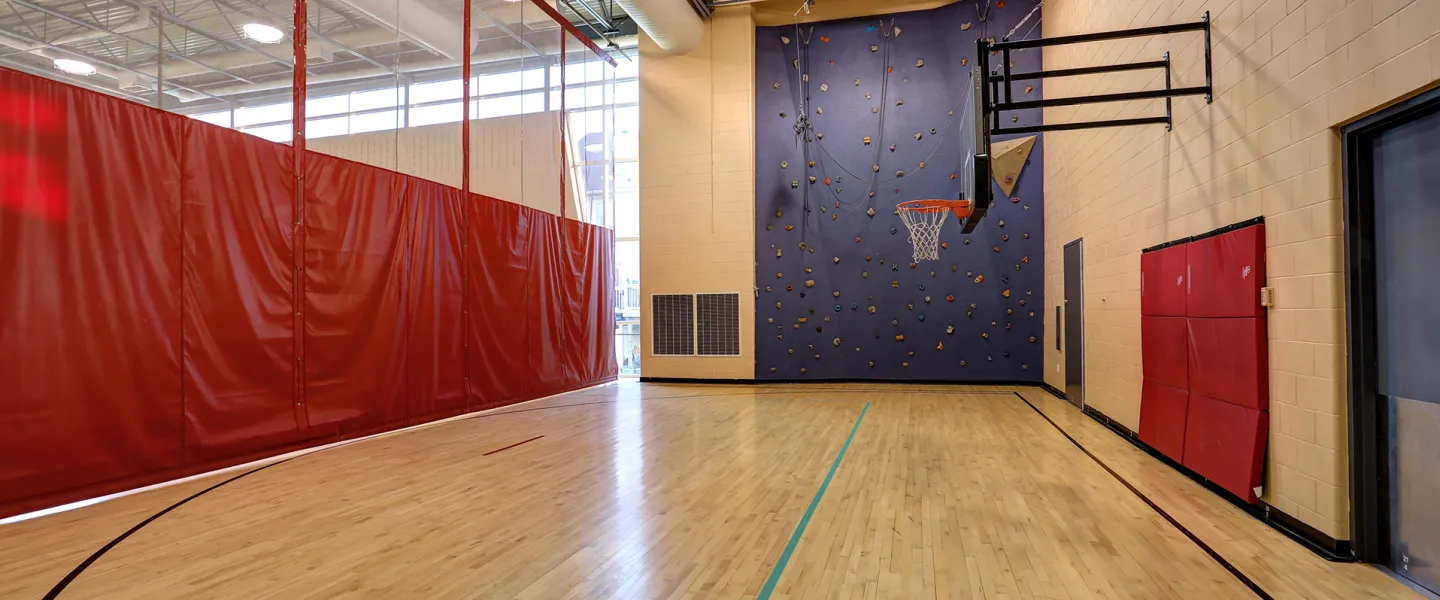 A rock climbing wall located in the gymnasium
