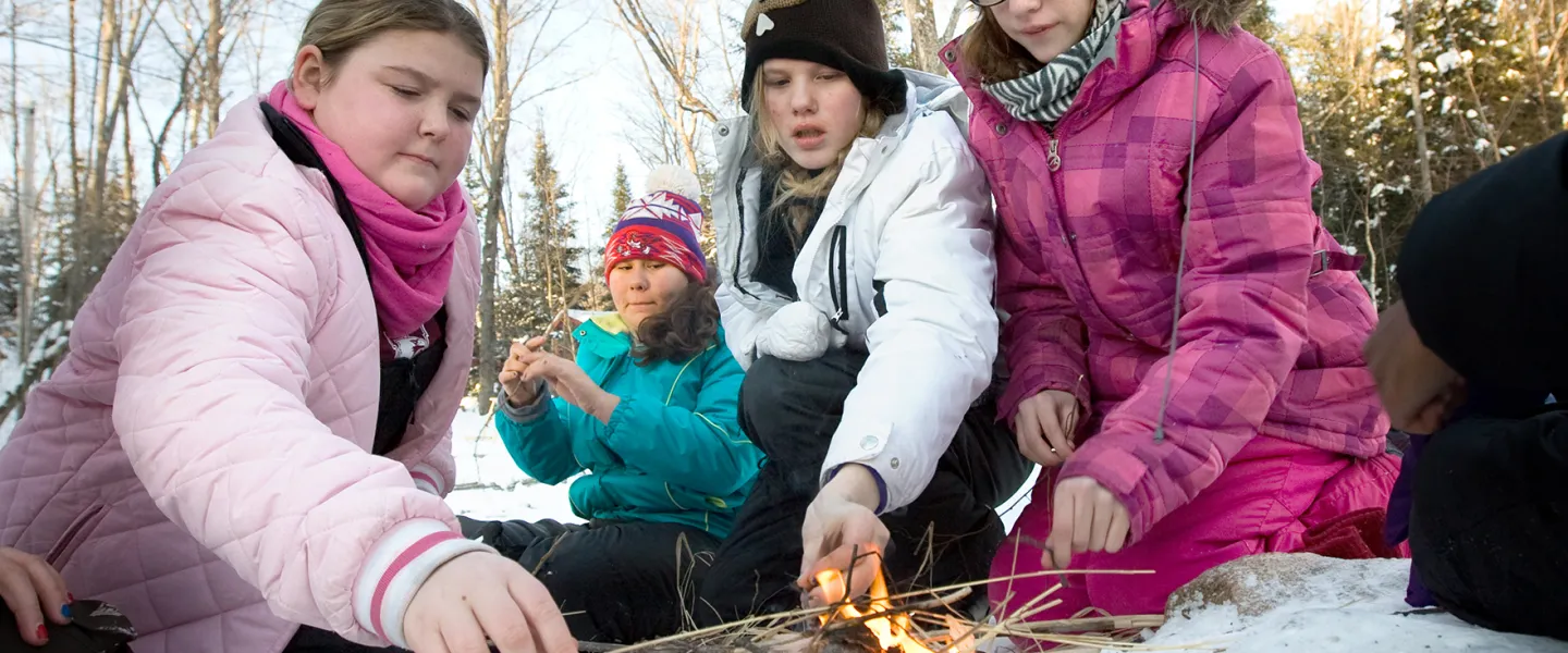 Youth girls building fire