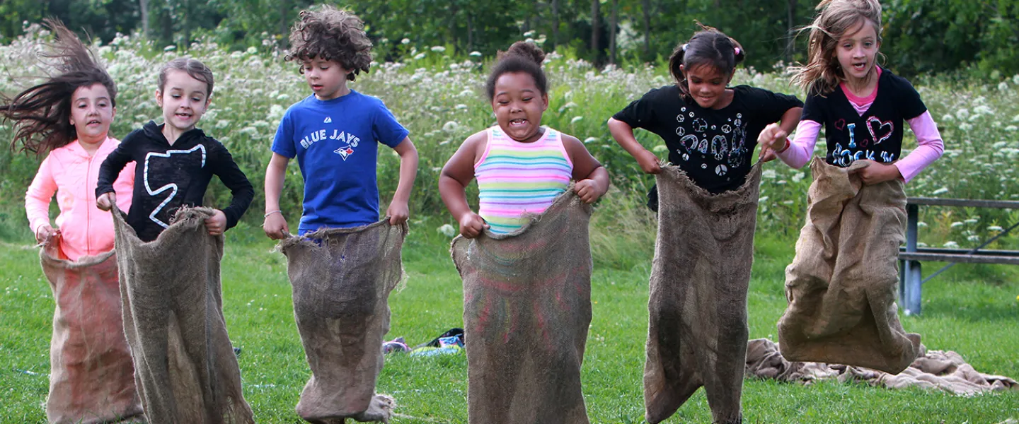 Group of campers in potato sack race