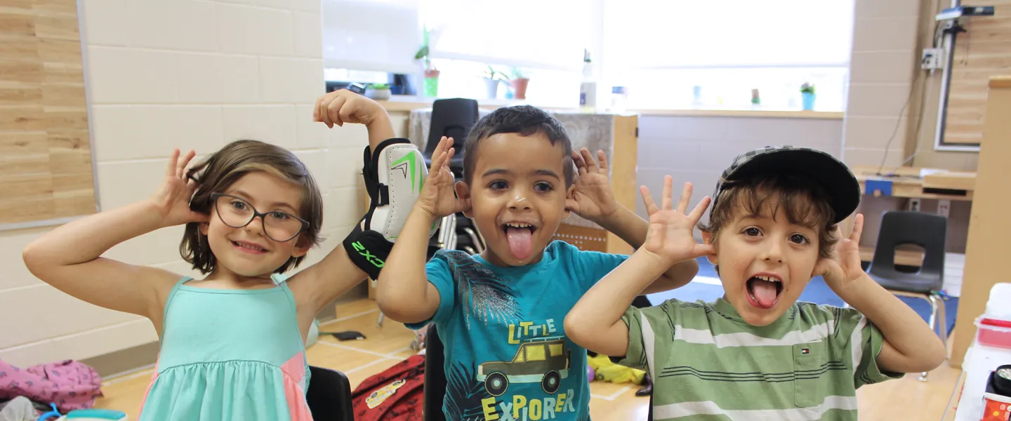 Group of campers smiling and silly posing for camera