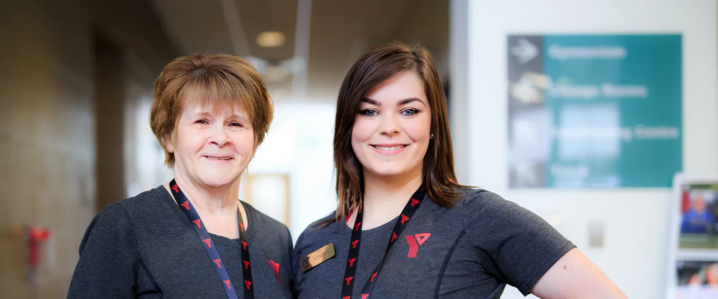 Two female YMCA staff posing and smiling