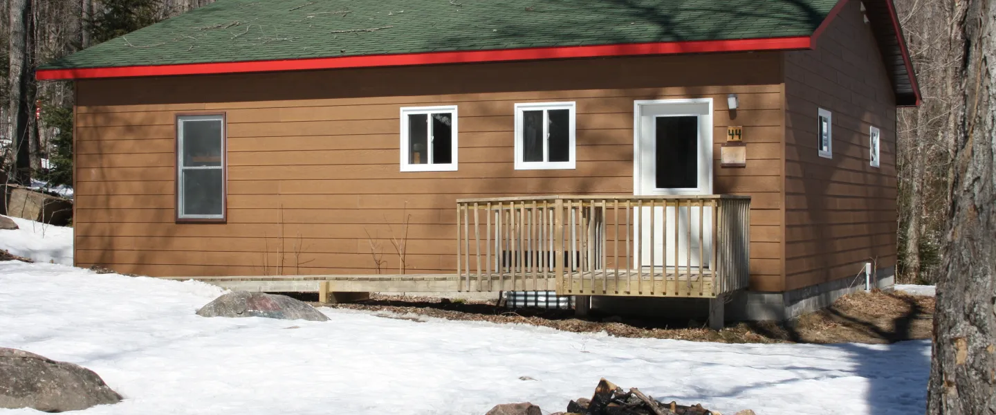 Exterior of winterized cabin with fire pit