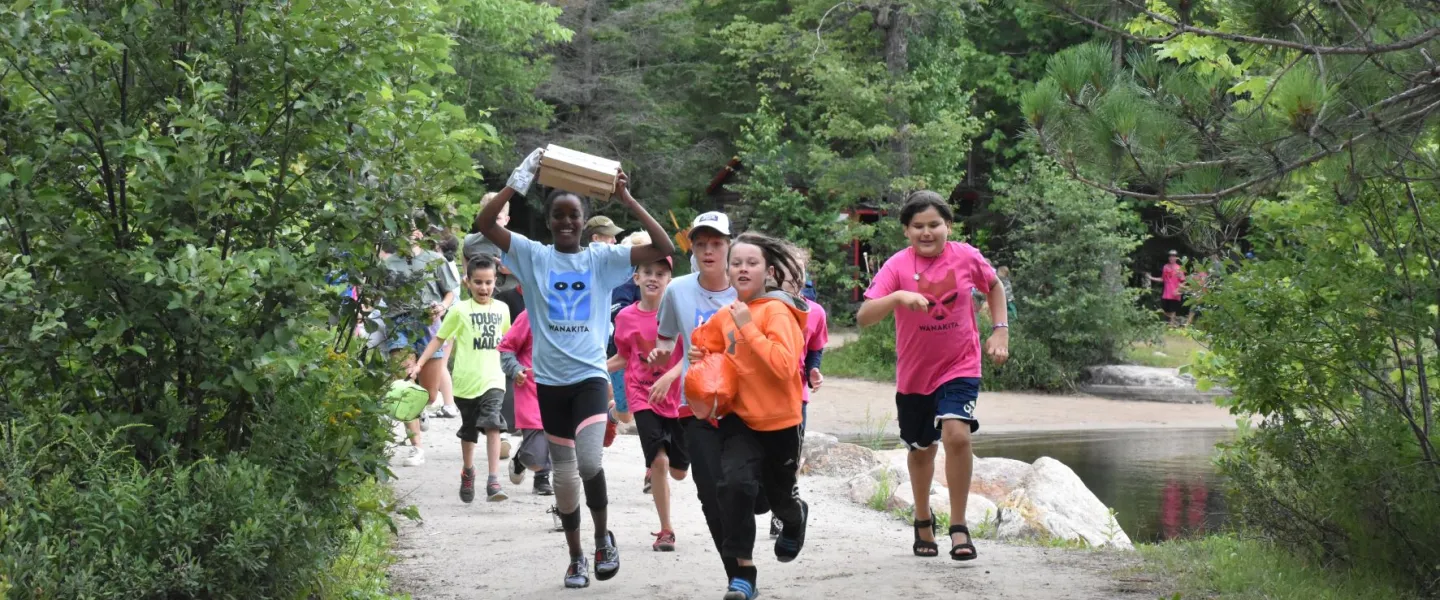 Campers running through camp