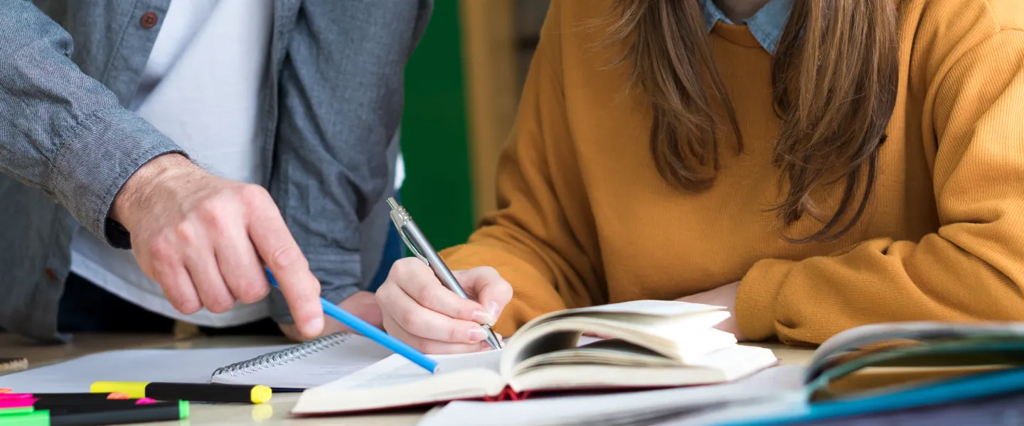 People are reading a notebook together