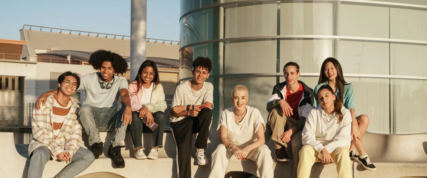 group of diverse youth sitting outside together