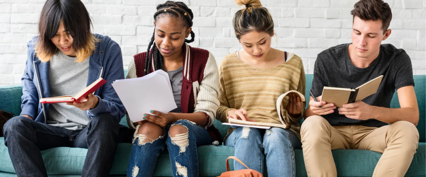 Youth looking at books studying