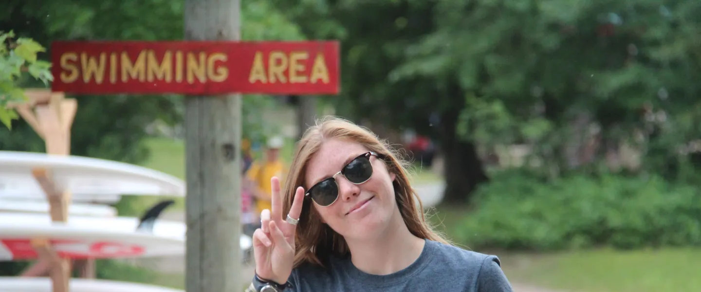 A Wanakita camp counsellor gives the peace sign