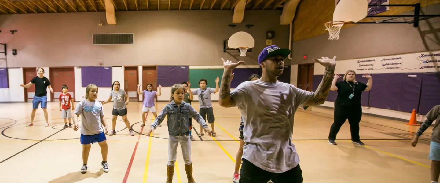 Children dancing in gymnasium with Hip Hop instructor
