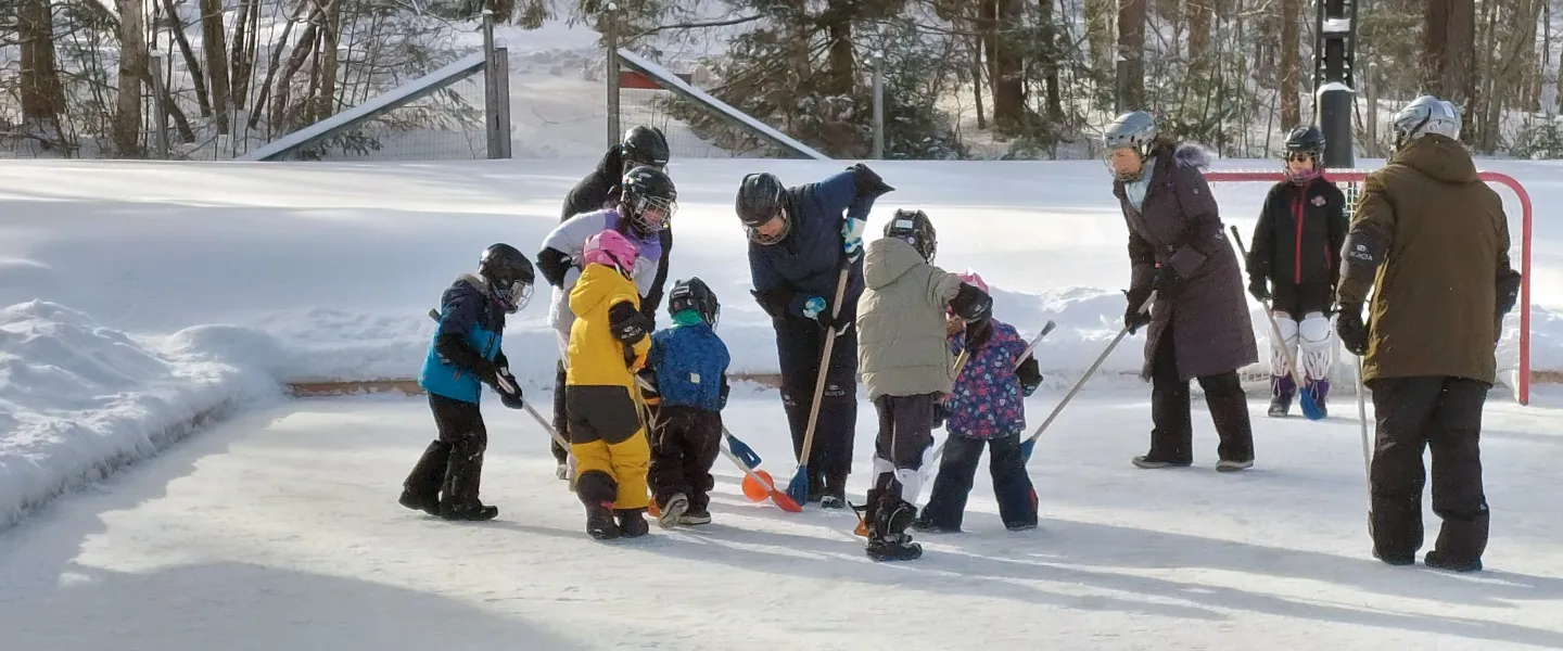 Families playing broomball