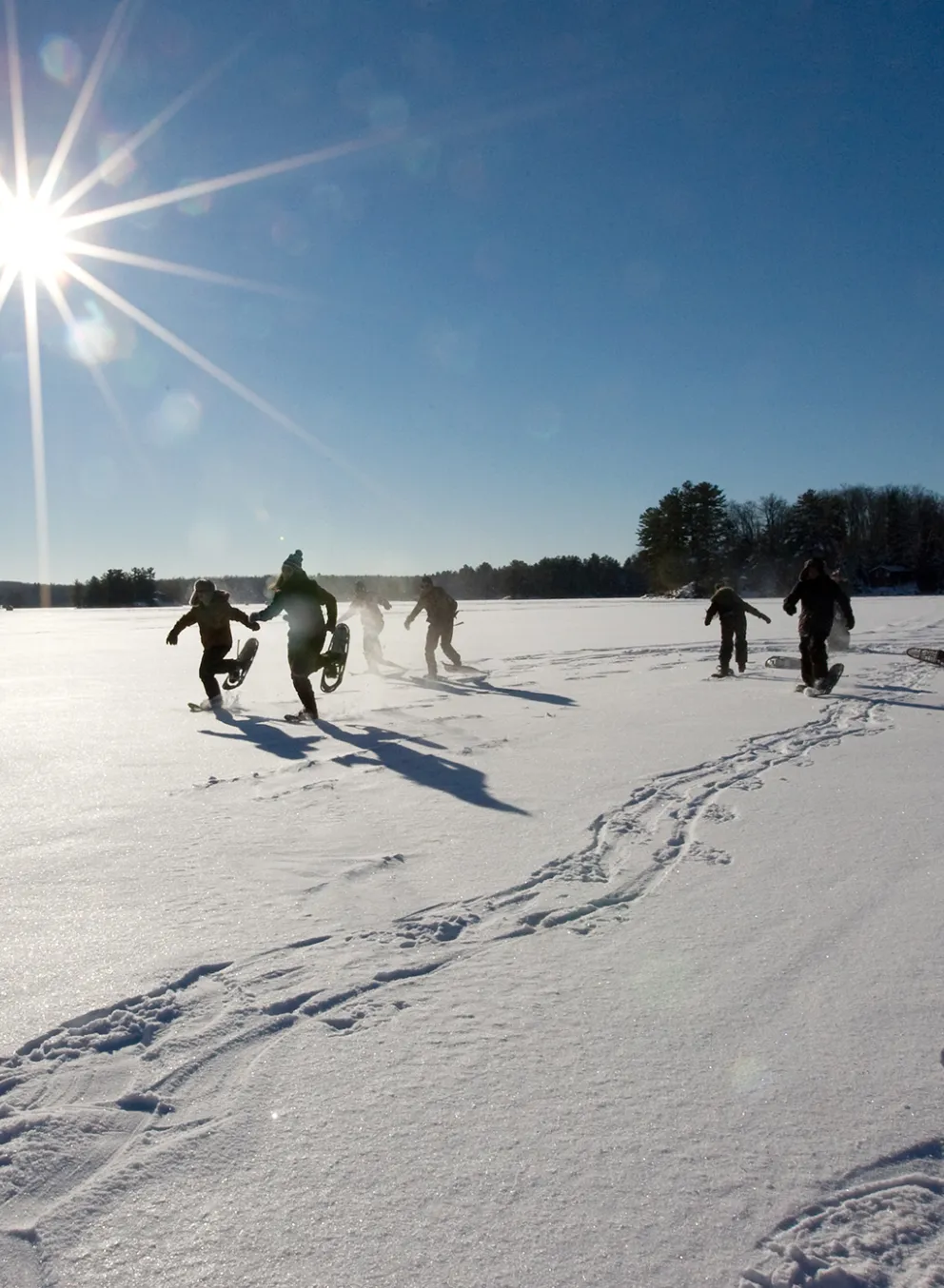 Youth snowshoeing on frozen lake