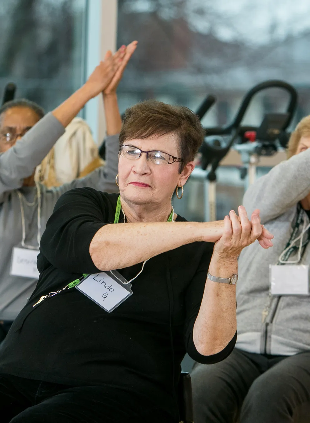 Senior members in chairs participating in Geras Dance