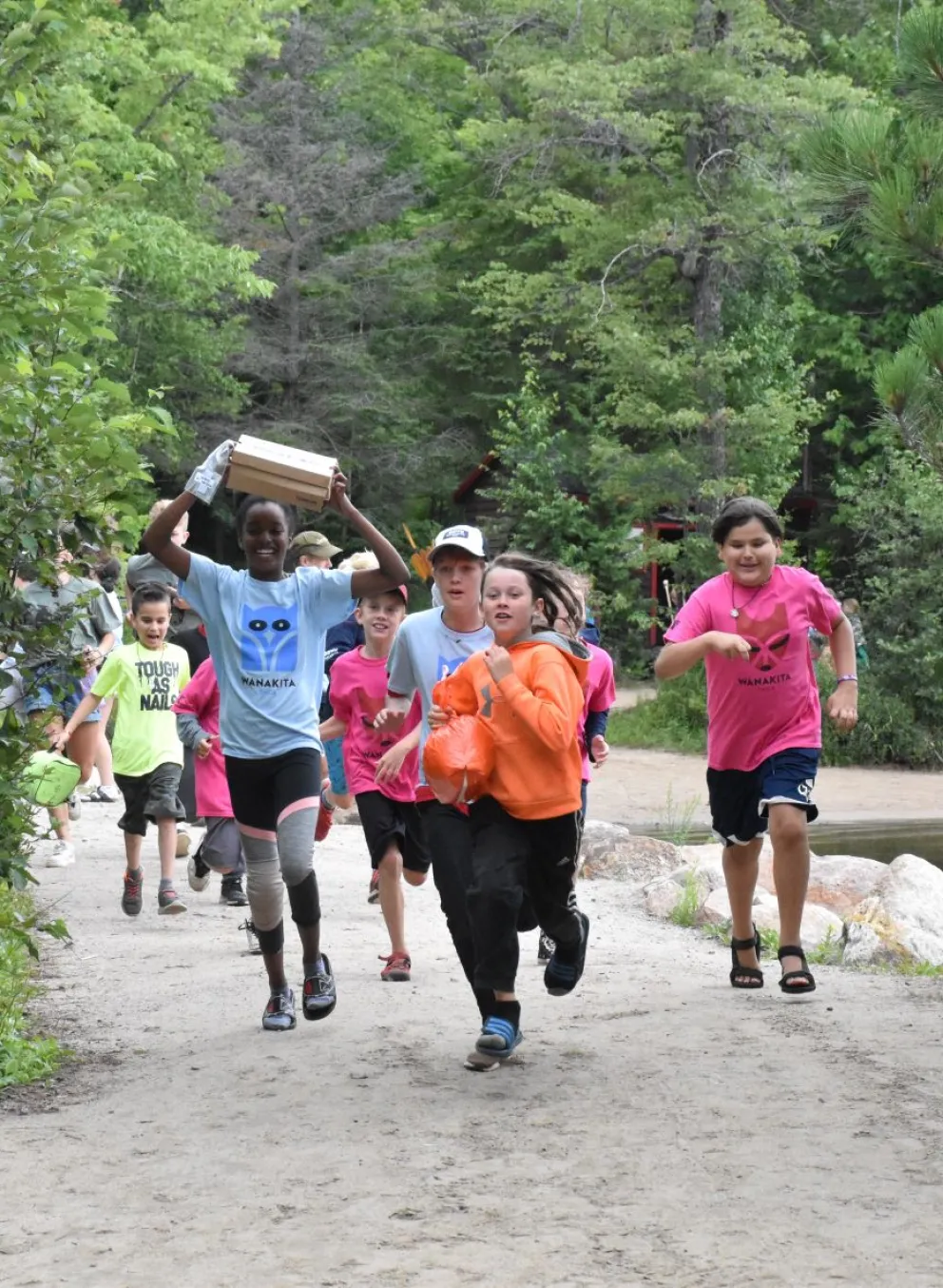 Campers running through camp