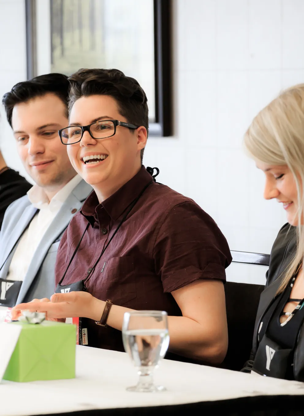 Four people sitting down at a table.