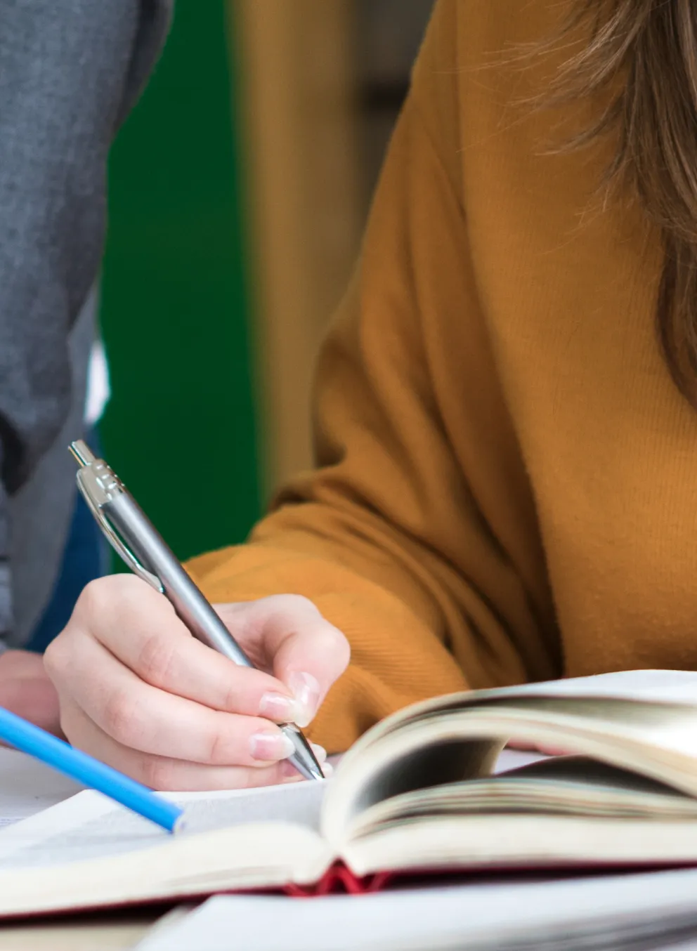 People are reading a notebook together