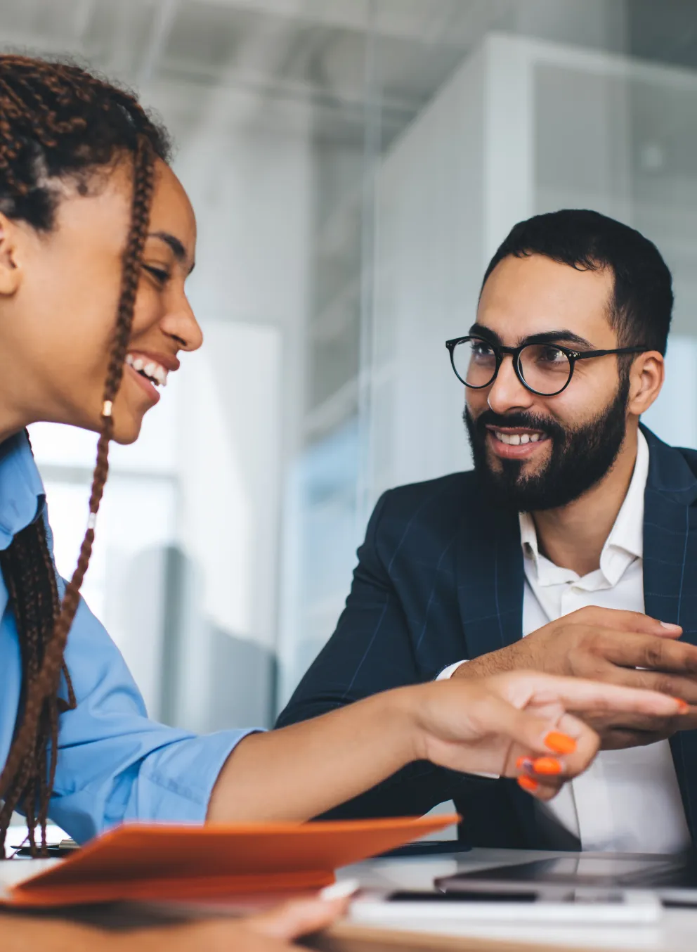 Two people looking at computer talking, smiling