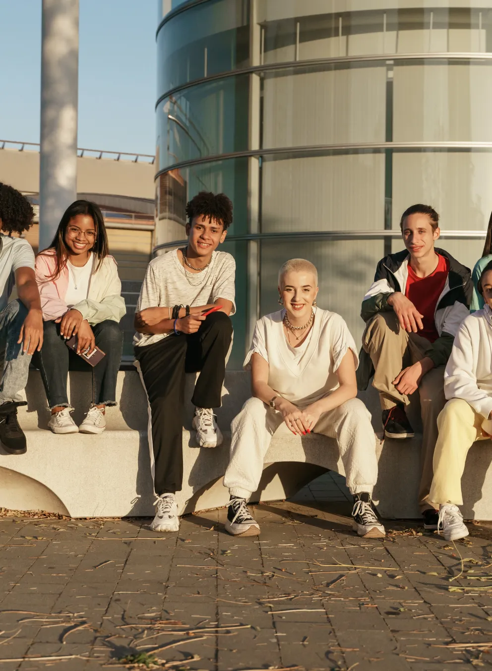 group of diverse youth sitting outside together