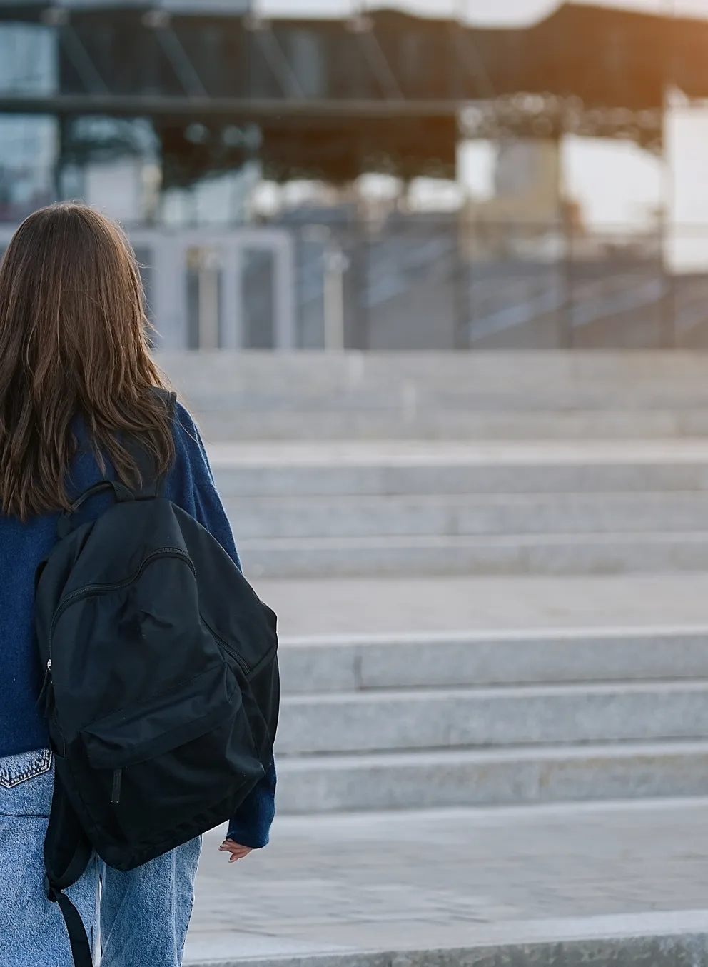 Two young people walking outside with backpacks