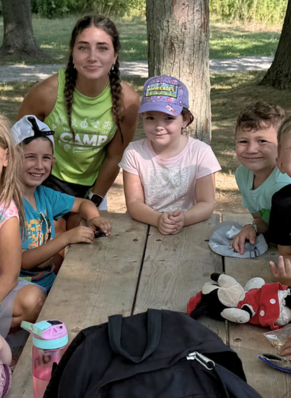 Group of kids at a bench smiling