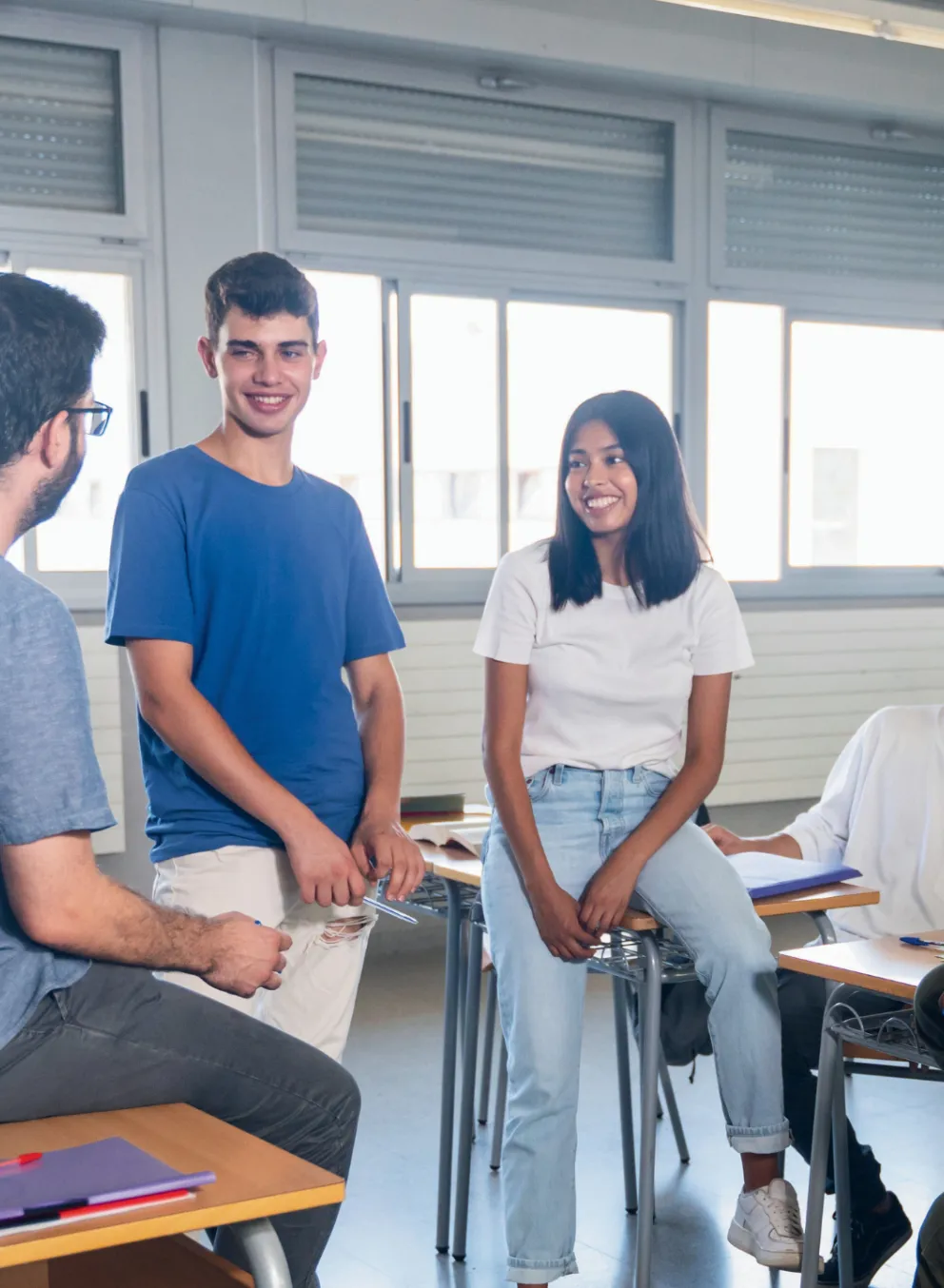 Groups of teens sitting in a classroom