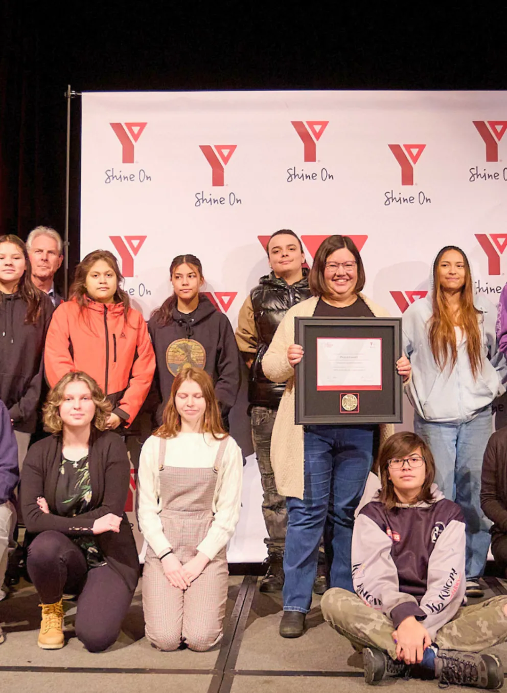 Group of people getting an award on stage