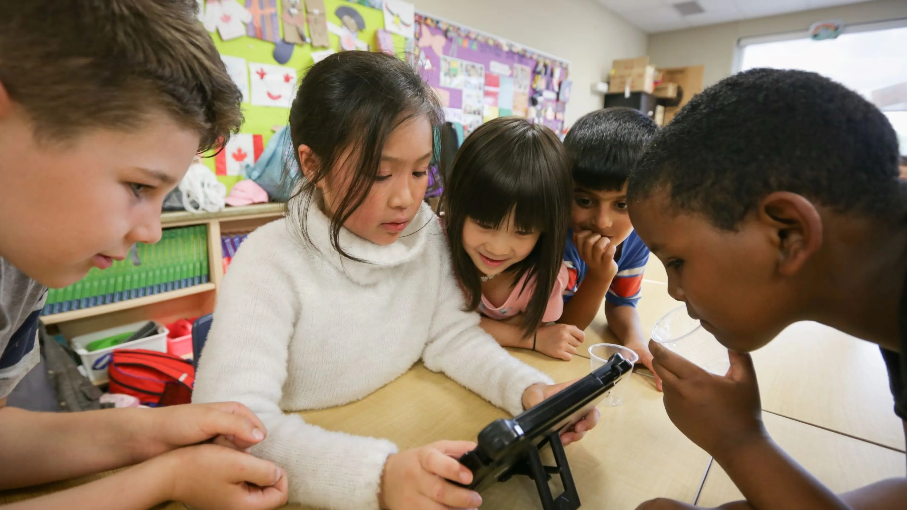 Children working on iPad at YMCA Beyond the Bell