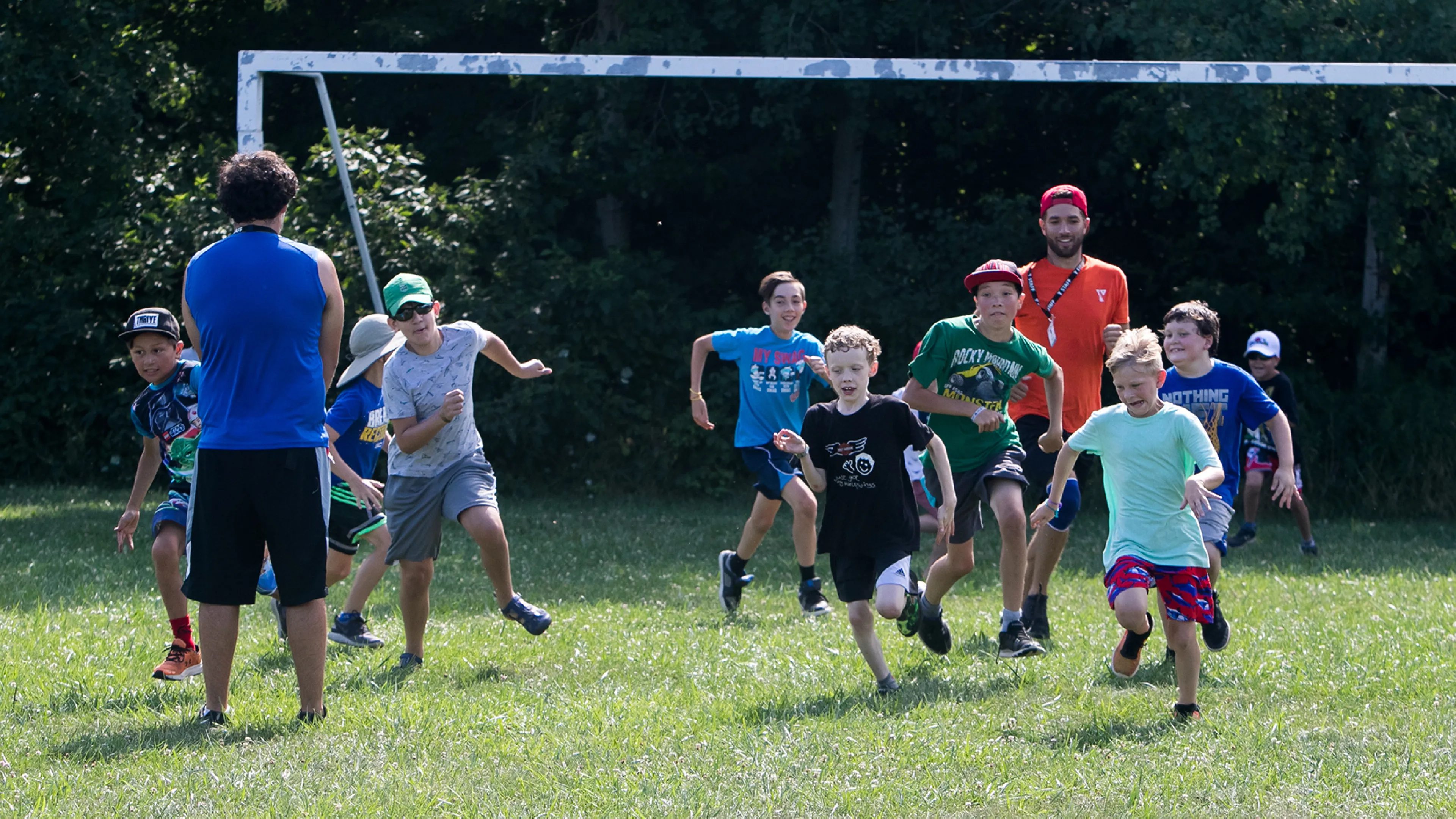 Group of campers playing soccer in grass