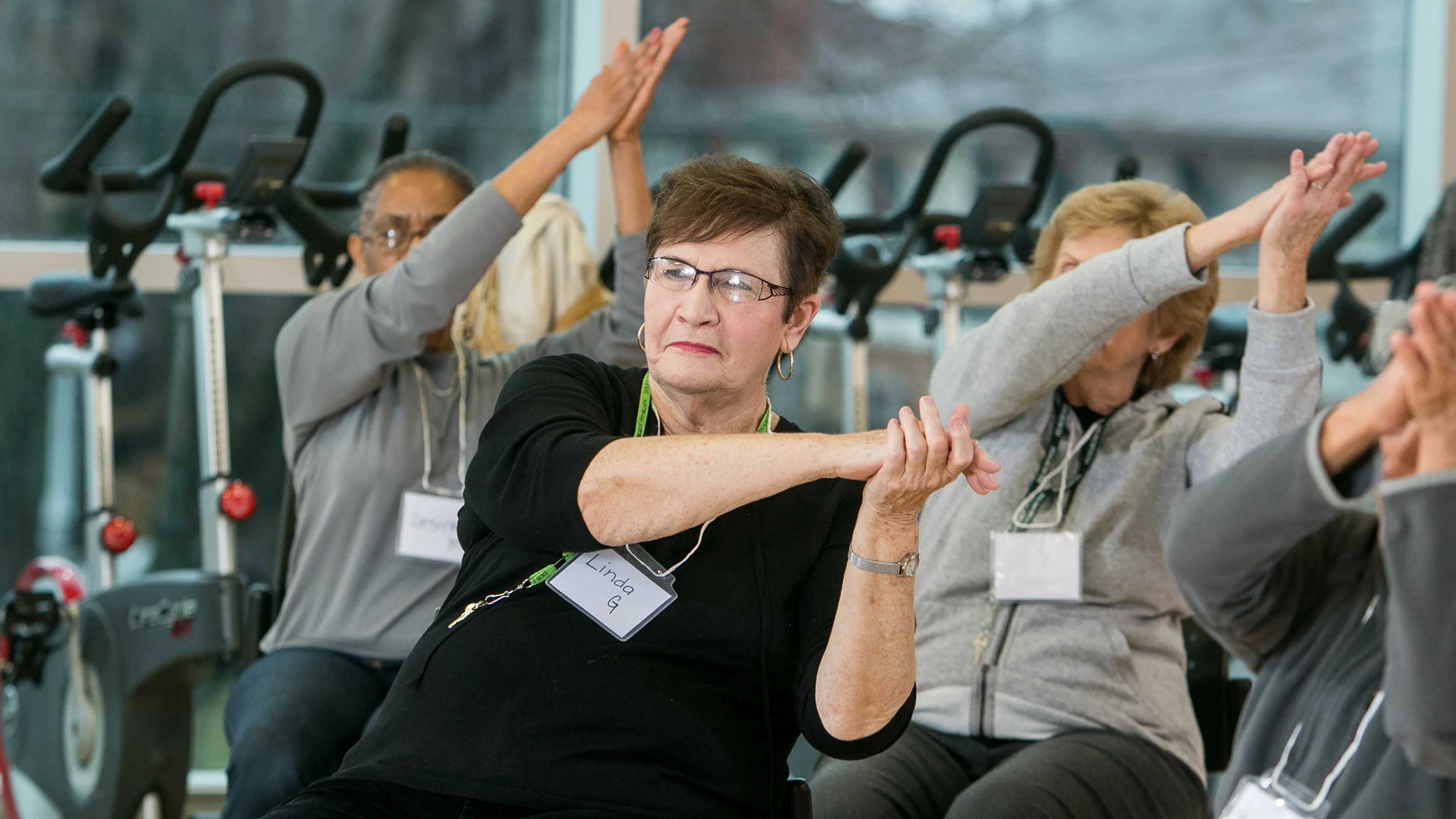 Senior members in chairs participating in Geras Dance