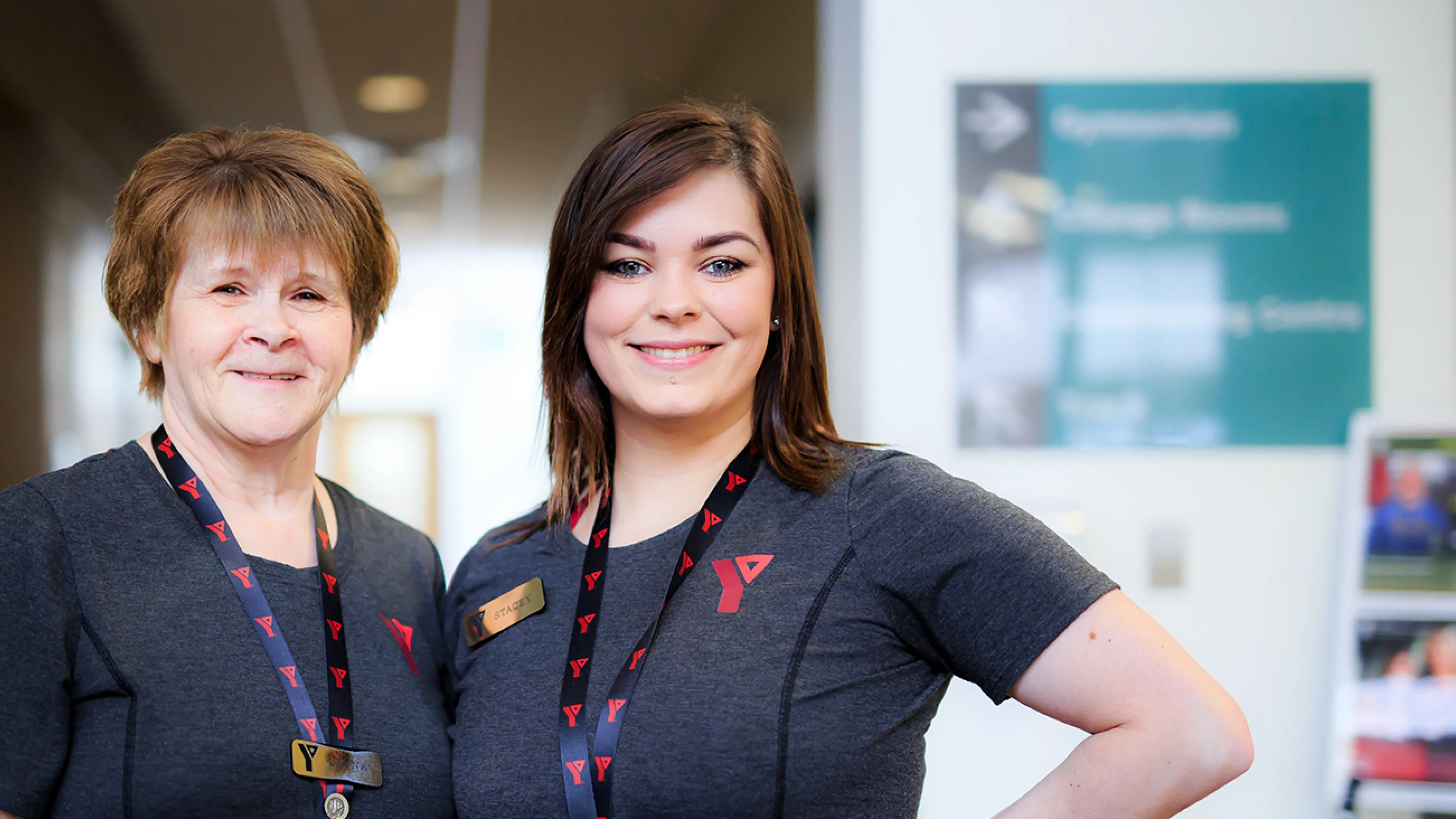 Two female YMCA staff posing and smiling
