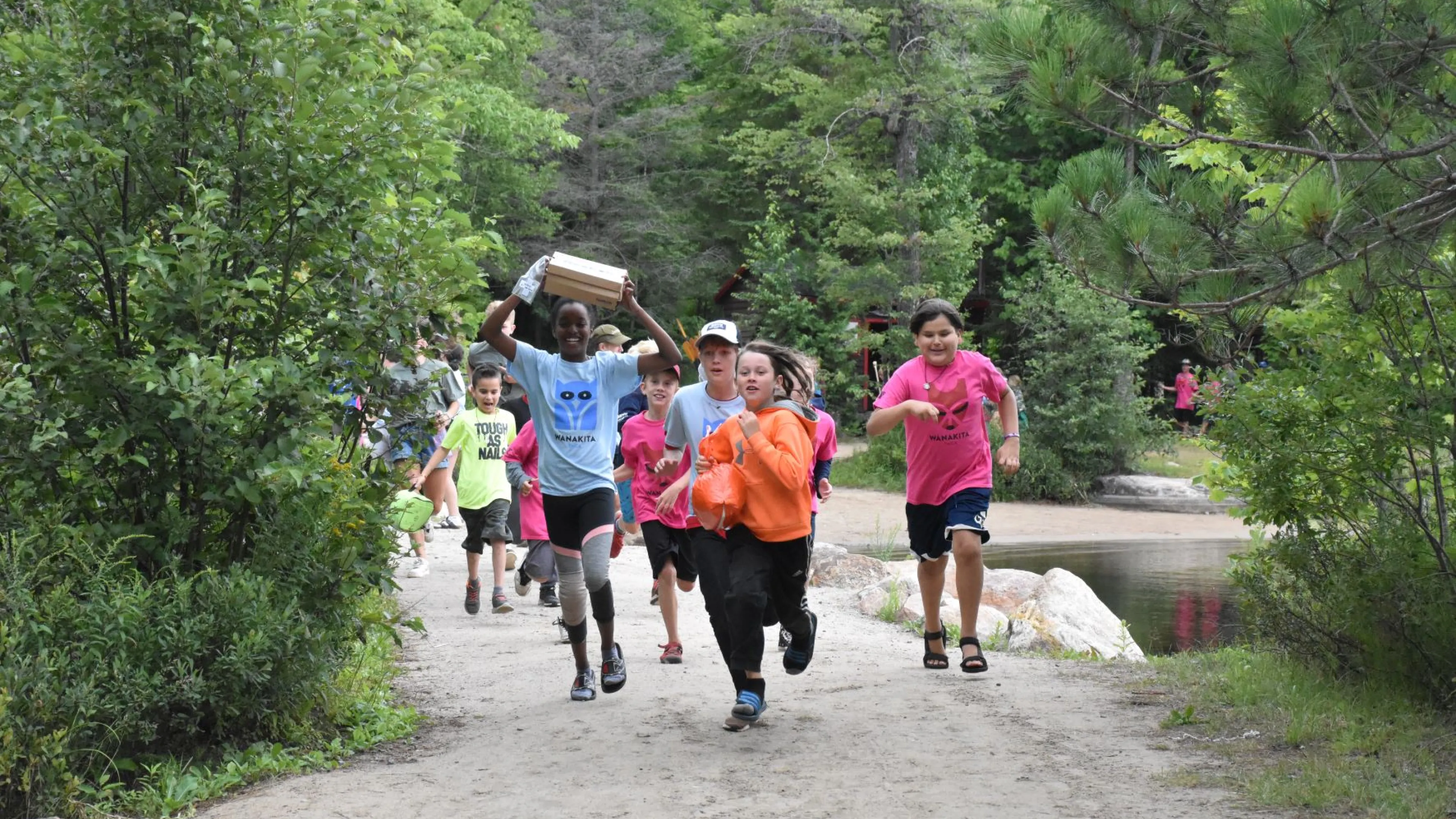 Campers running through camp