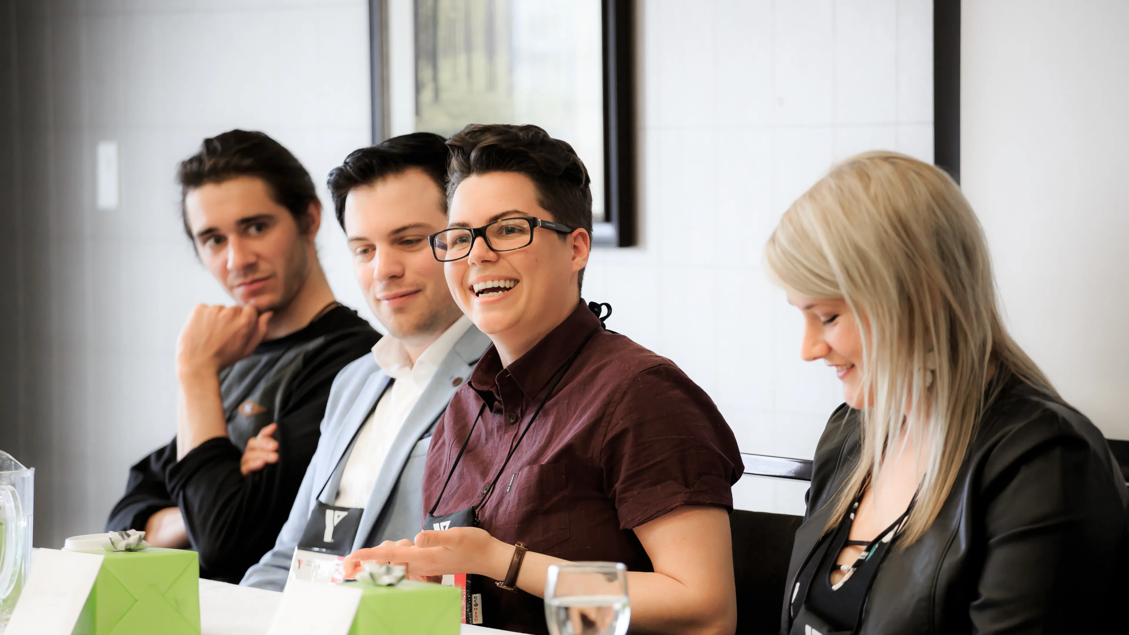 Four people sitting down at a table.
