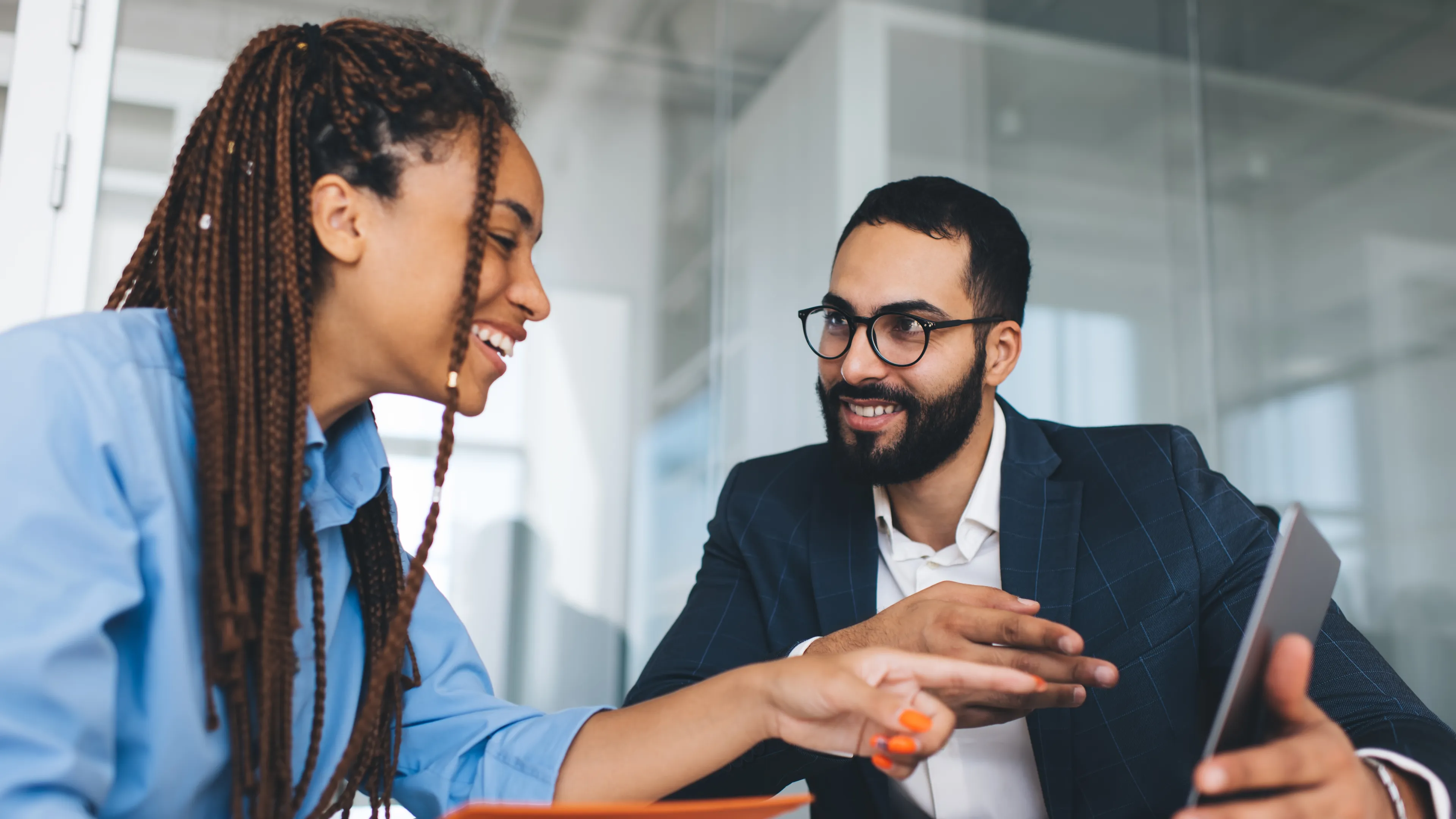 Two people looking at computer talking, smiling