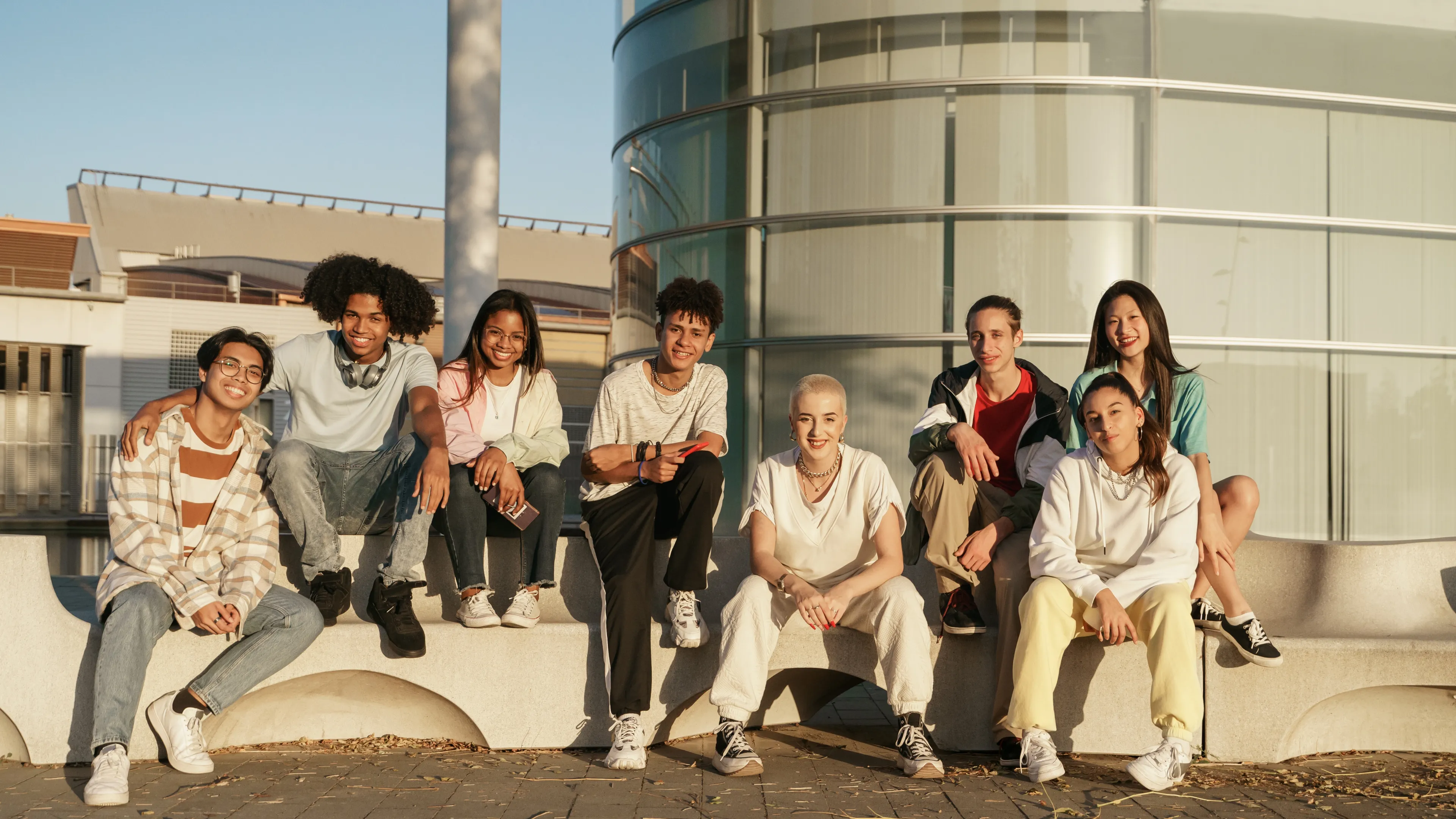group of diverse youth sitting outside together