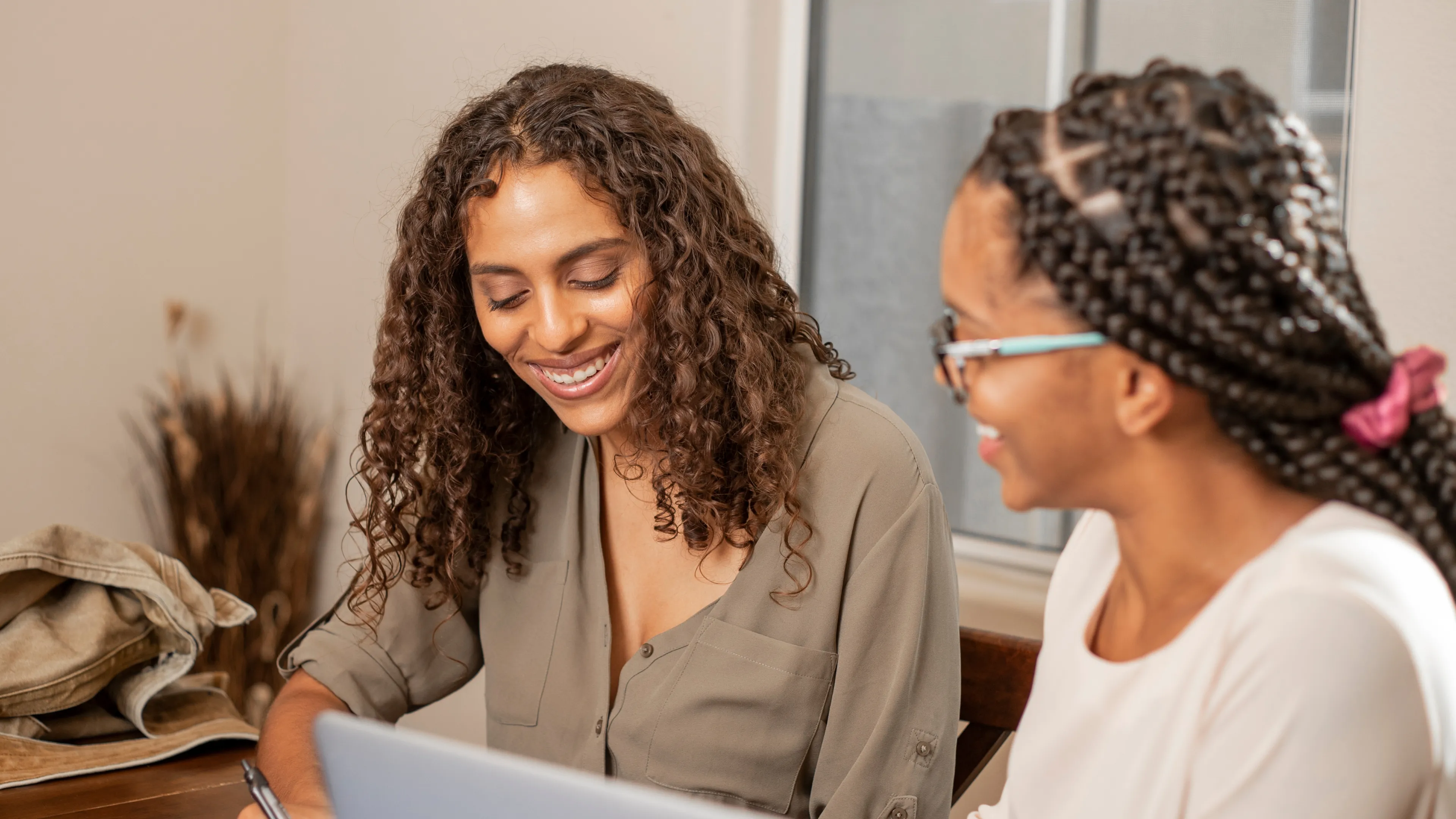 Tutor supporting young person with learning